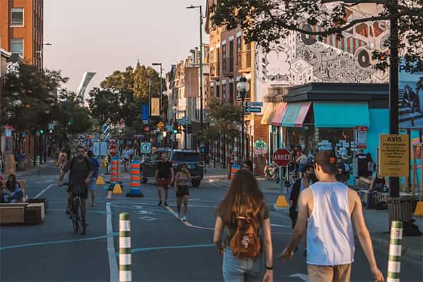 a busy urban street with people walking, construction and vibrant colors